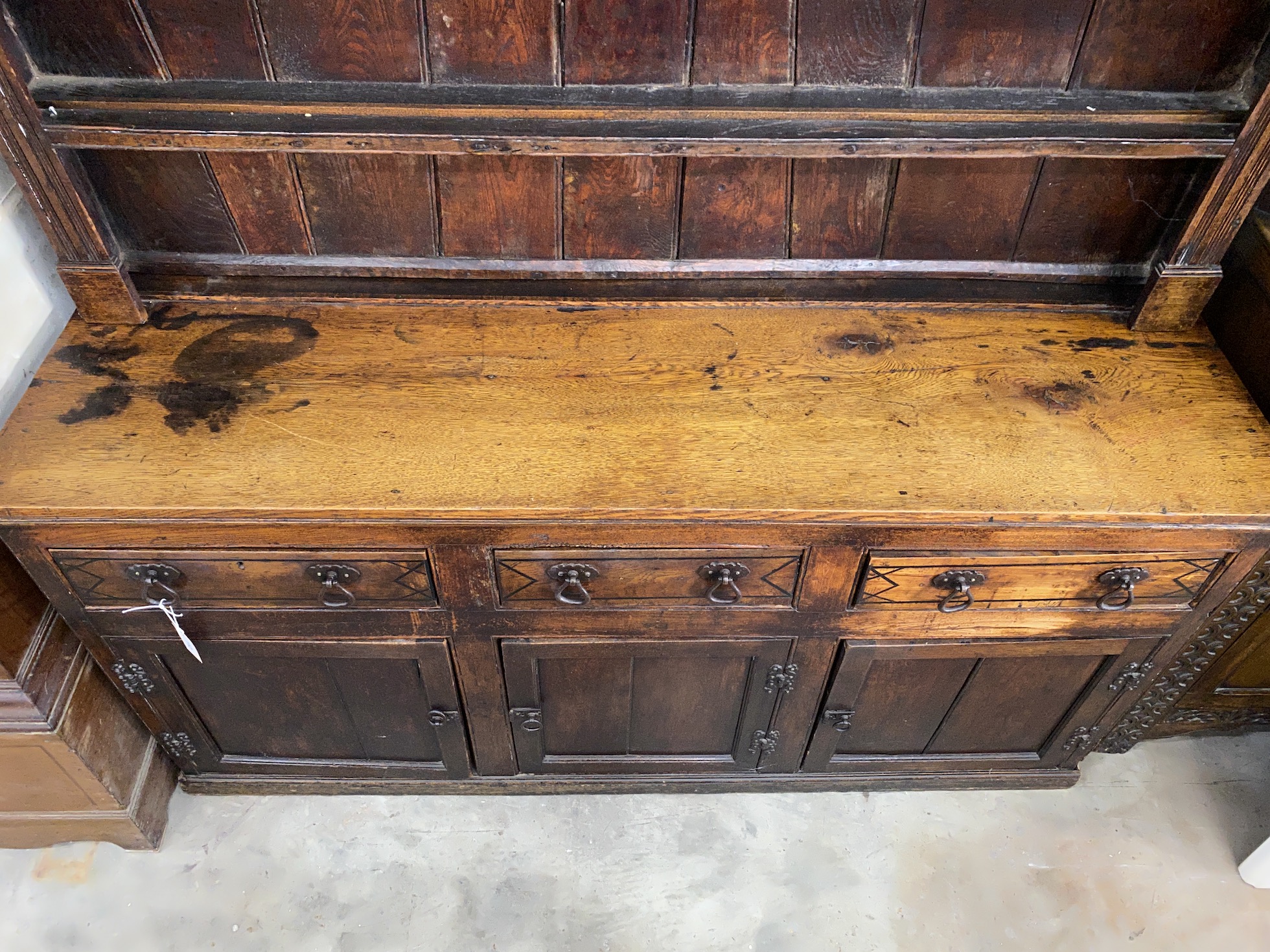 An 18th century provincial oak and elm dresser with associated boarded rack, length 163cm, depth 49cm, height 190cm